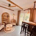 W Studio living area with rattan shelving and morning light